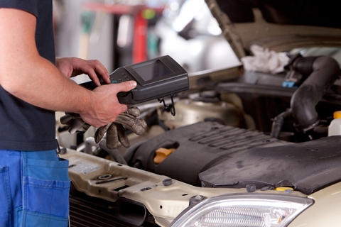Mechanic Checking Engine with Diagnostic Tool