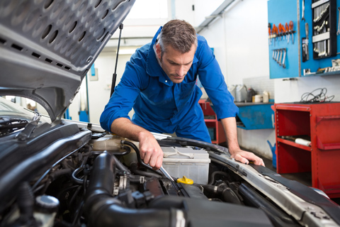 Mechanic Looking Inside Engine Bay
